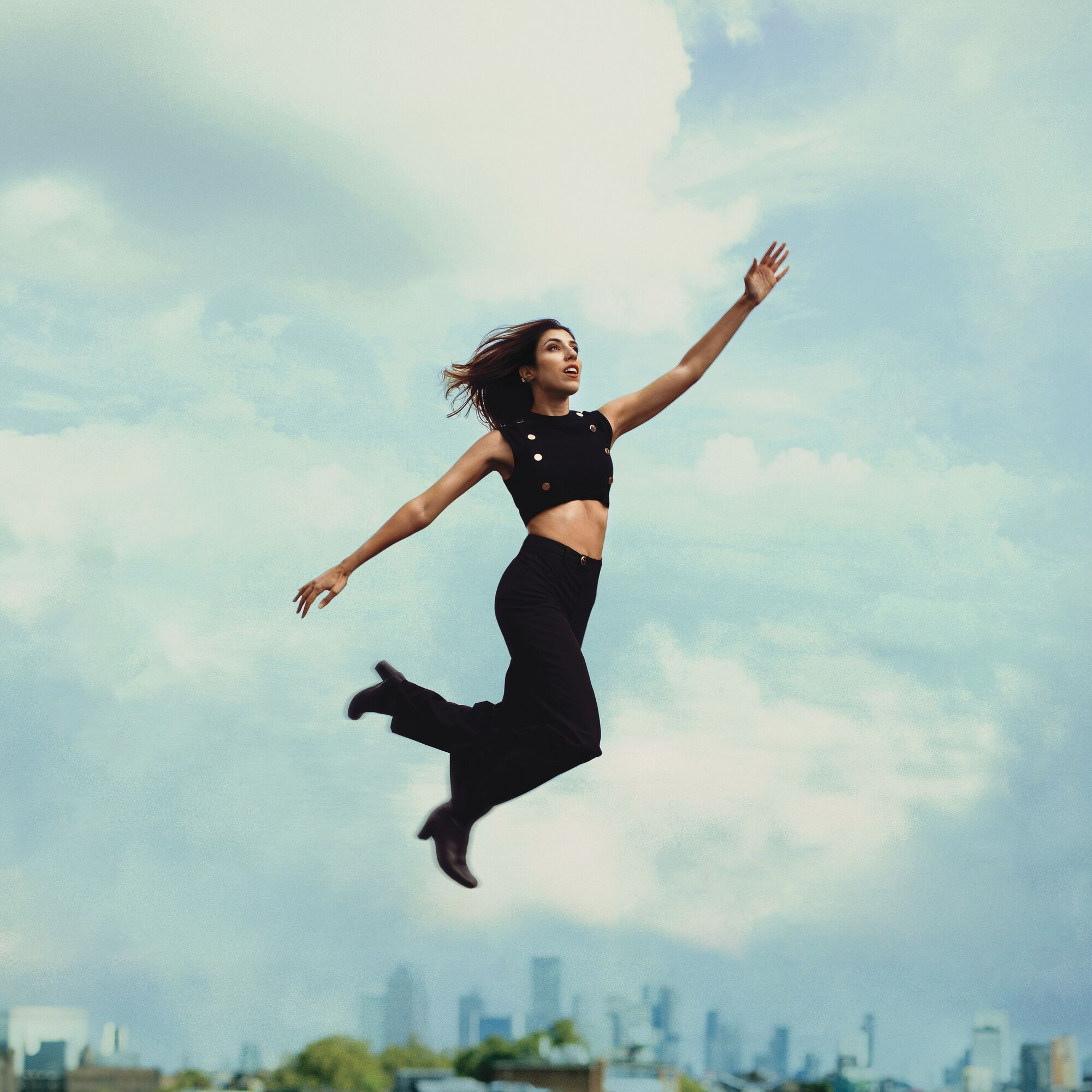 Alba leaping against a London sky, from the Questions Unanswered cover shoot
